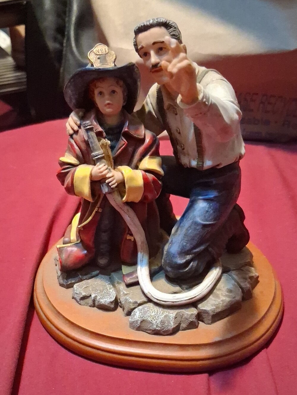 mark. Hand-Painted Firefighter Hero Figurine in Red and Cream